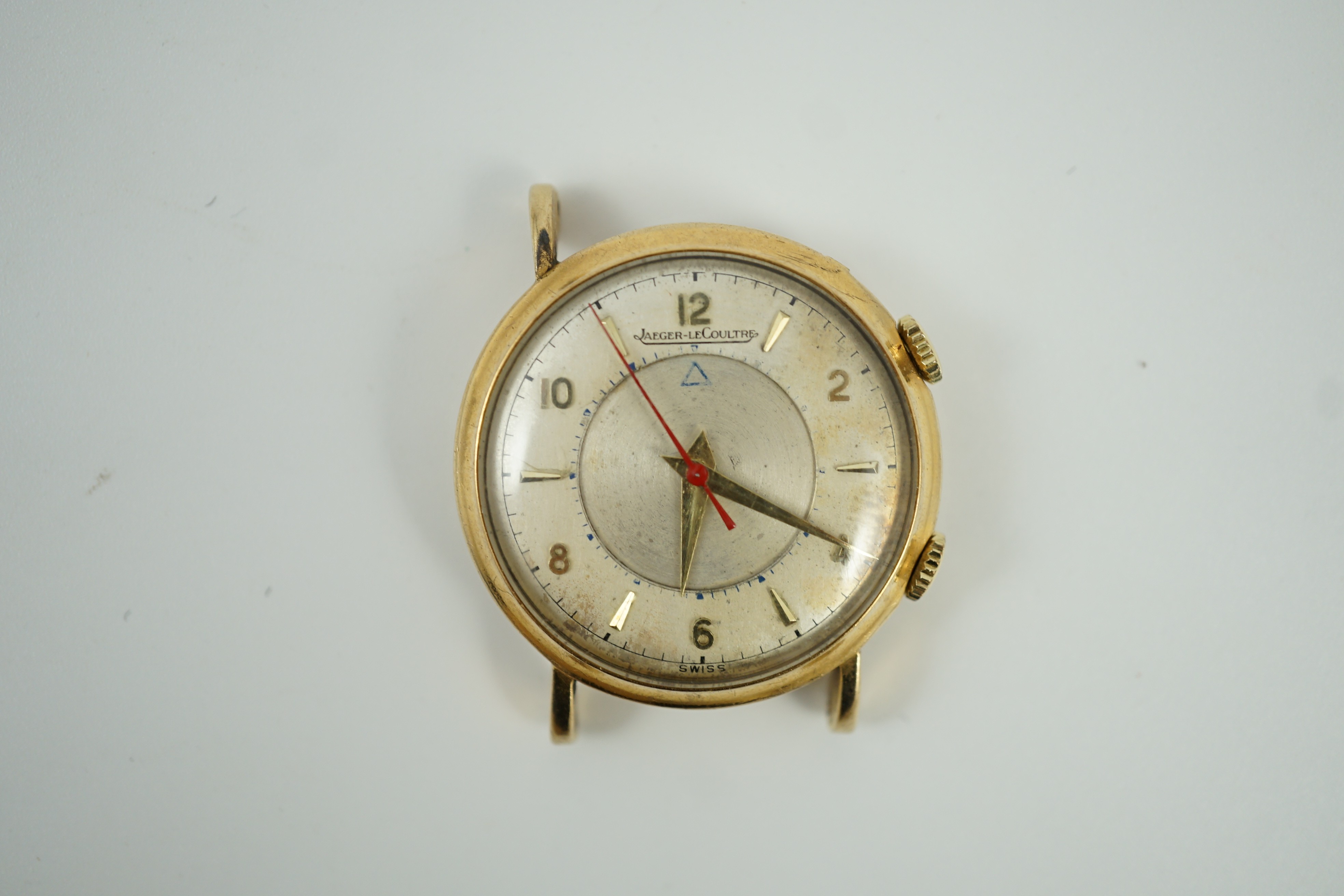A gentleman's 9ct gold Jaeger LeCoultre memovox wrist watch, with case back inscription and lacking one lug, case diameter 32mm, gross weight 26.4 grams.